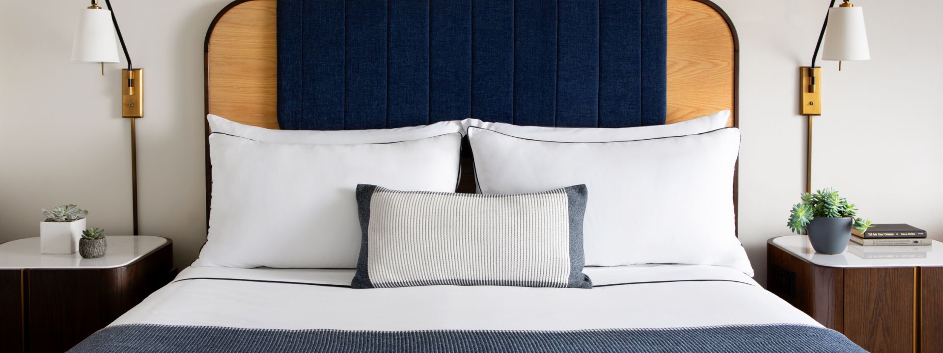 A king bed in a modern hotel room