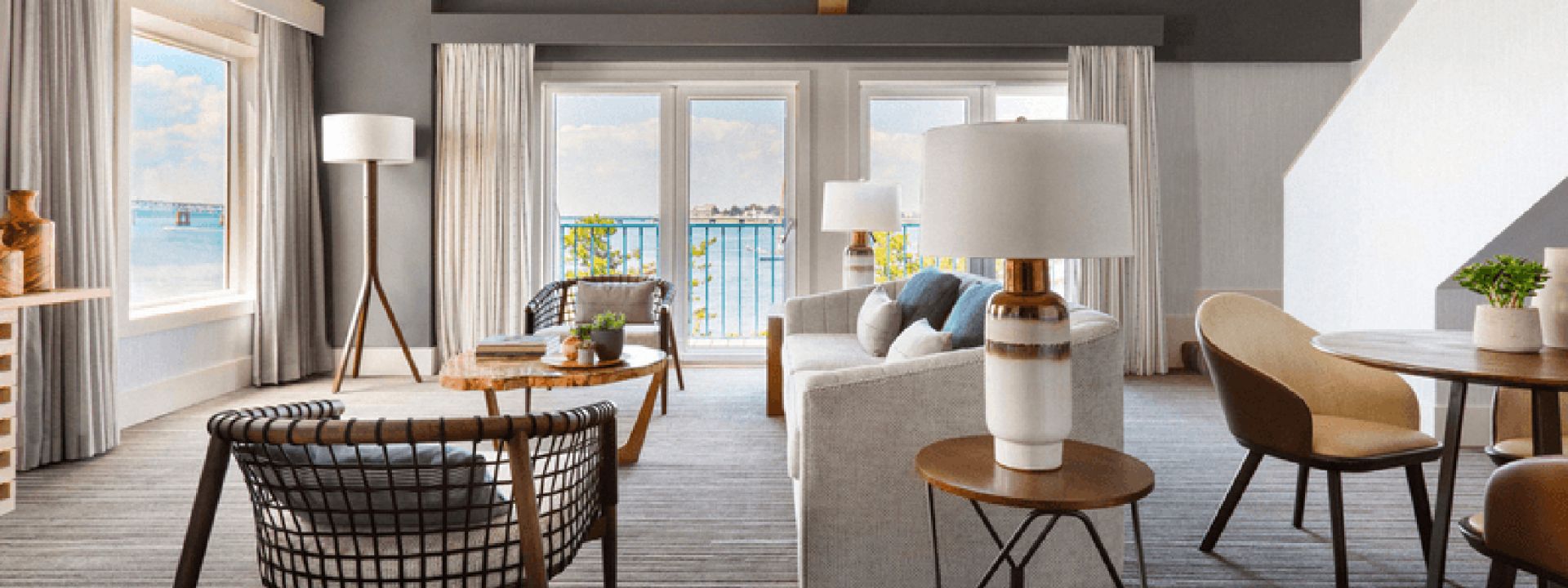 A large sitting area in a waterfront hotel suite.