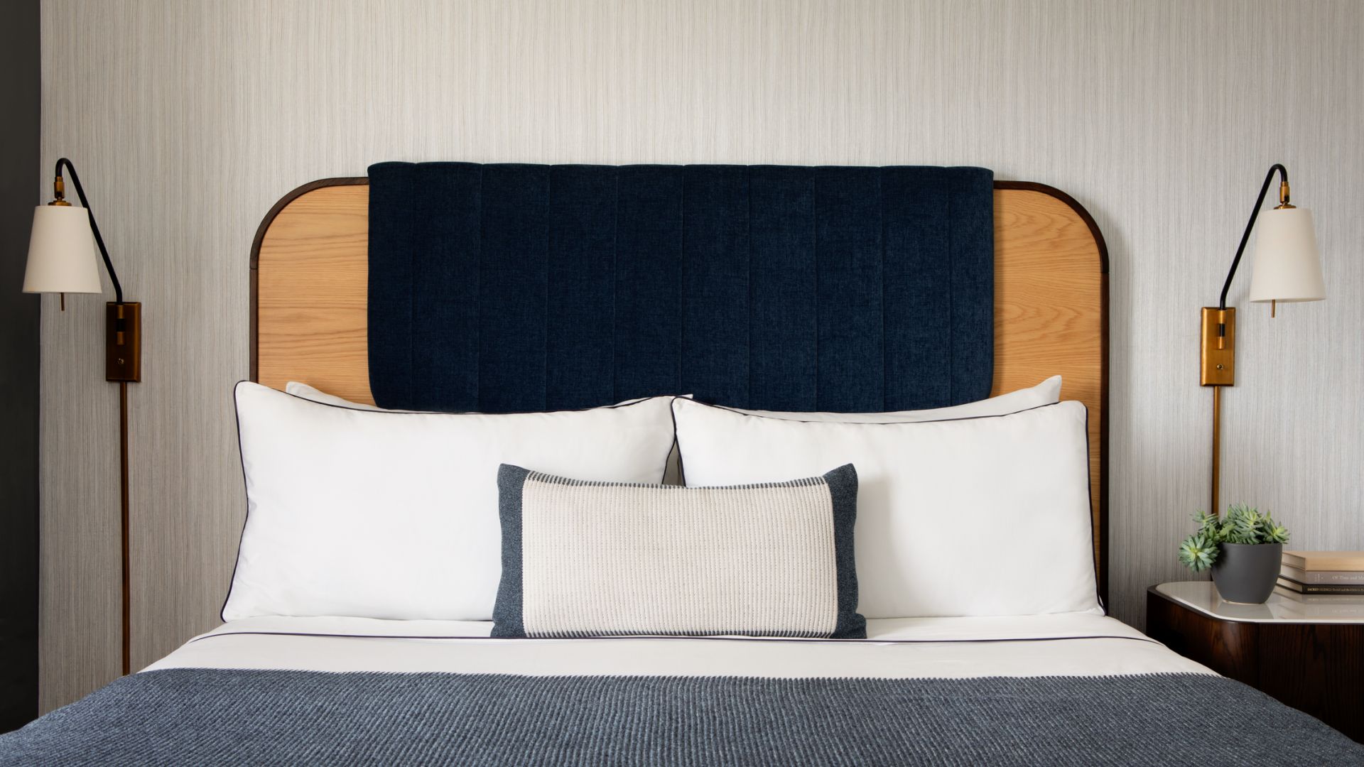 A king bed in a modern hotel suite.
