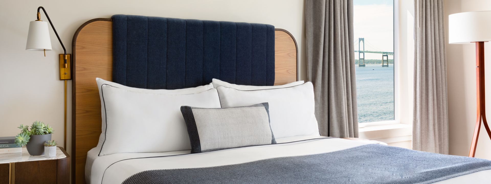 A king bed in a modern hotel suite with ocean views.