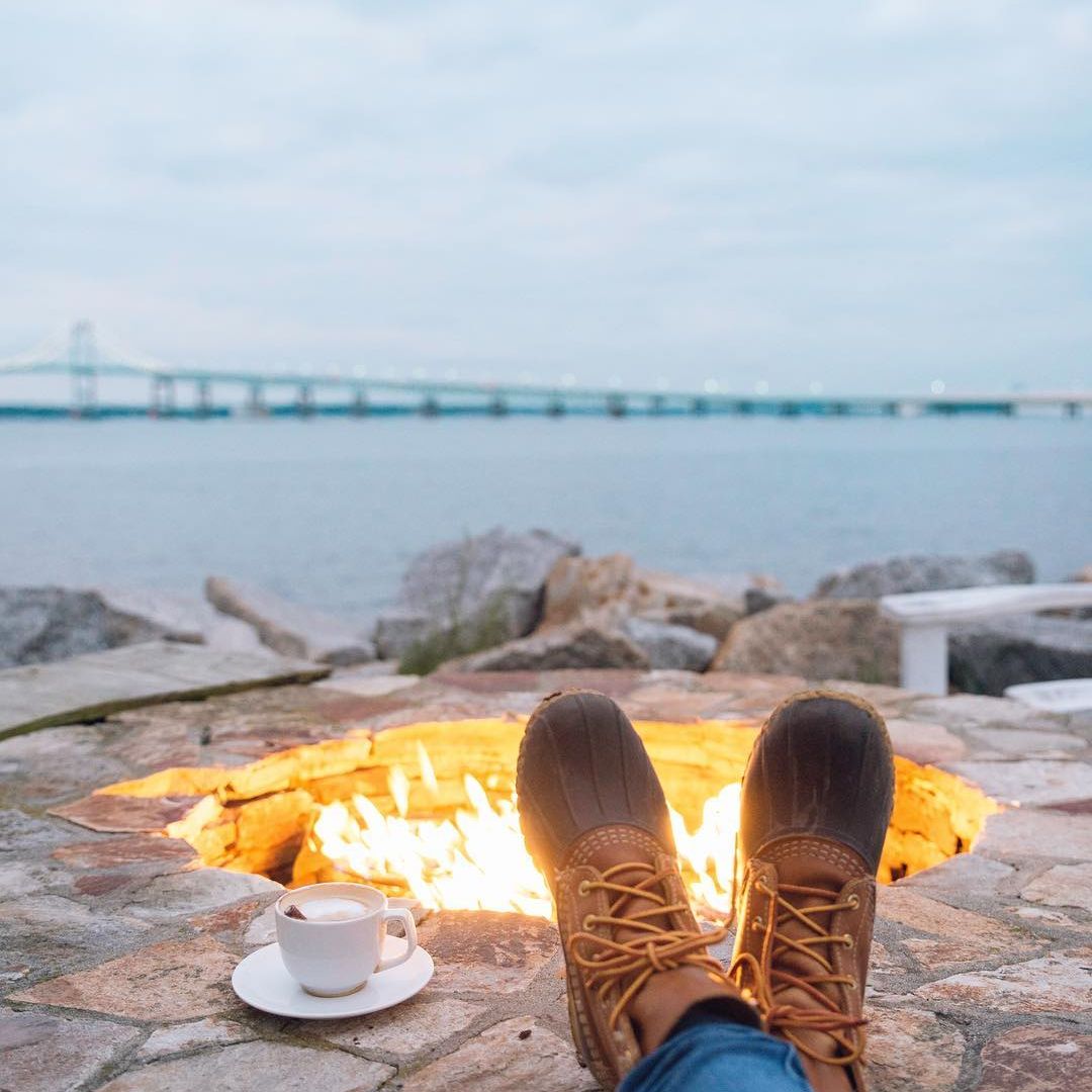 boots and coffee in front of a seaside firepit
