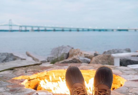 boots and coffee in front of a seaside firepit