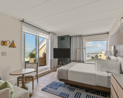 Guest room with king bed overlooking ocean
