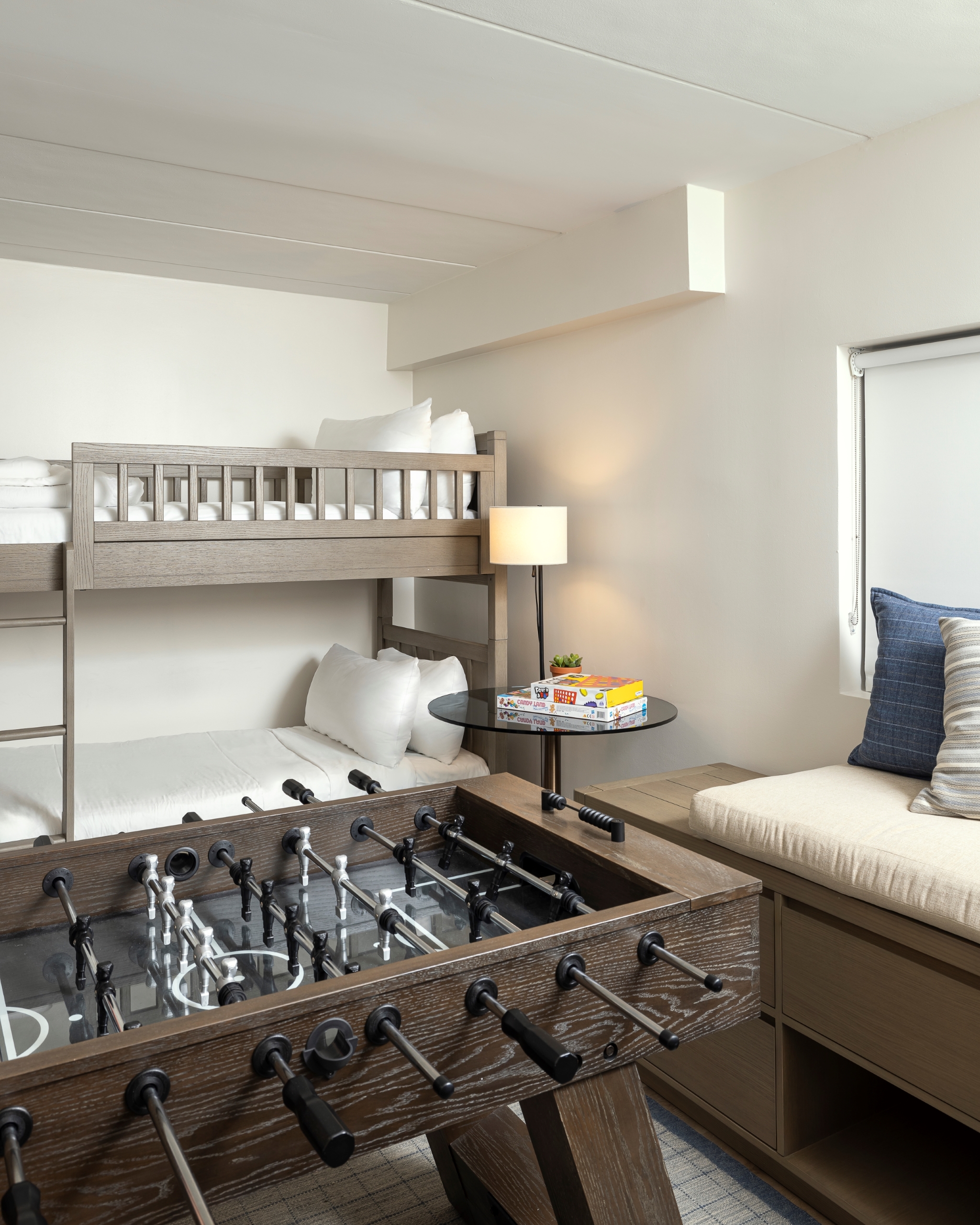 A family suite with bunk beds, a foosball table, and a reading nook