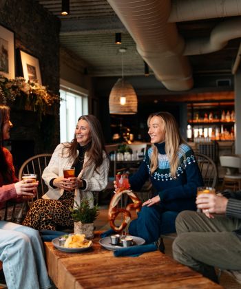a group of people sitting at a table with drinks
