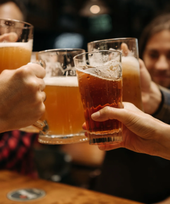 A group of people clinking beer glasses together.